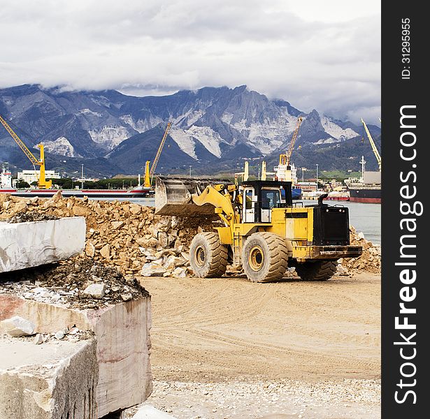 Yellow buldozer in a harbour