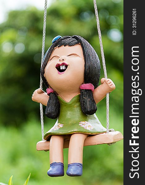 Clay doll girl on a swing. Clay doll girl on a swing.