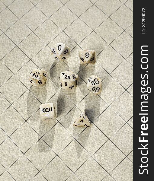 Polyhedral dice on blank roleplay game grid