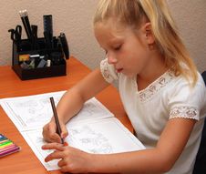 Girl Sits At A Table And Draws Stock Photos