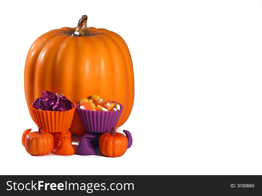 Sheer treat bags filled with candy sitting in front of a large pumpkin with witch’s shoes filled with candy. Sheer treat bags filled with candy sitting in front of a large pumpkin with witch’s shoes filled with candy