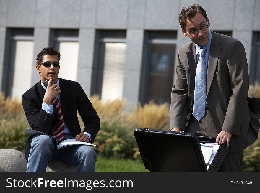 Two business men are looking at something in distance. Two business men are looking at something in distance