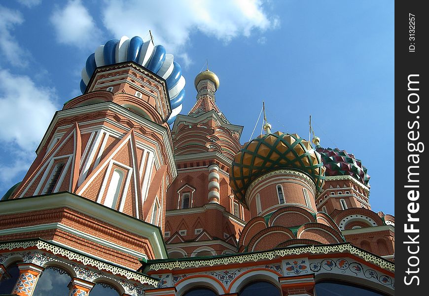 Historical church of st.Basil on Red Square in Moscow. Top of church, domes, sky and clouds are visible. Historical church of st.Basil on Red Square in Moscow. Top of church, domes, sky and clouds are visible.