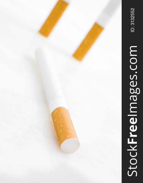 Three cigarettes on white background. Three cigarettes on white background.