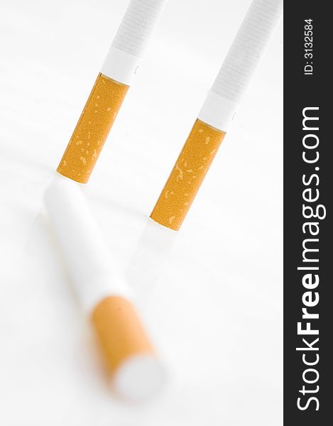 Three cigarets on white background.