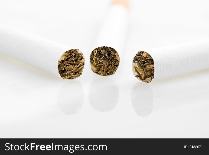 Three cigarets on white background.