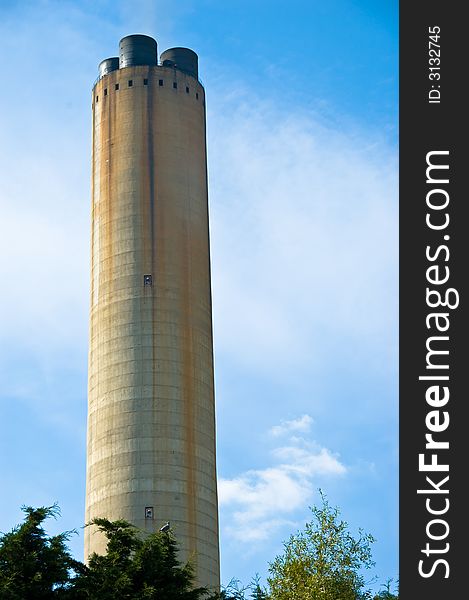 Large industrial chimney stack against a blue sky