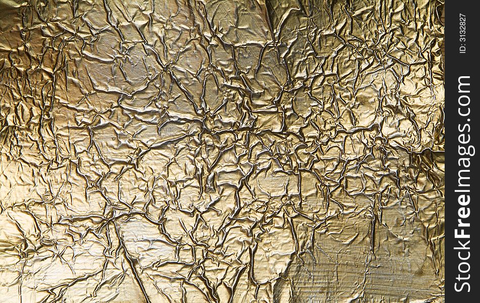 Wrinkled and scratched golden metal background. Wrinkled and scratched golden metal background