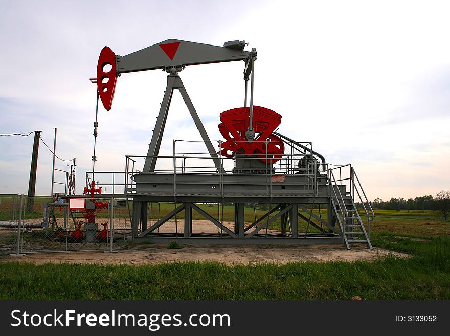 Oil pump on a green field. Oil pump on a green field.