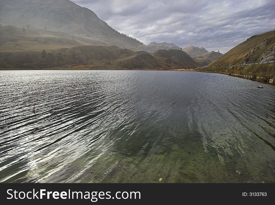 Mountain lake in the Swiss Alpes in cloudy autumn day. Mountain lake in the Swiss Alpes in cloudy autumn day