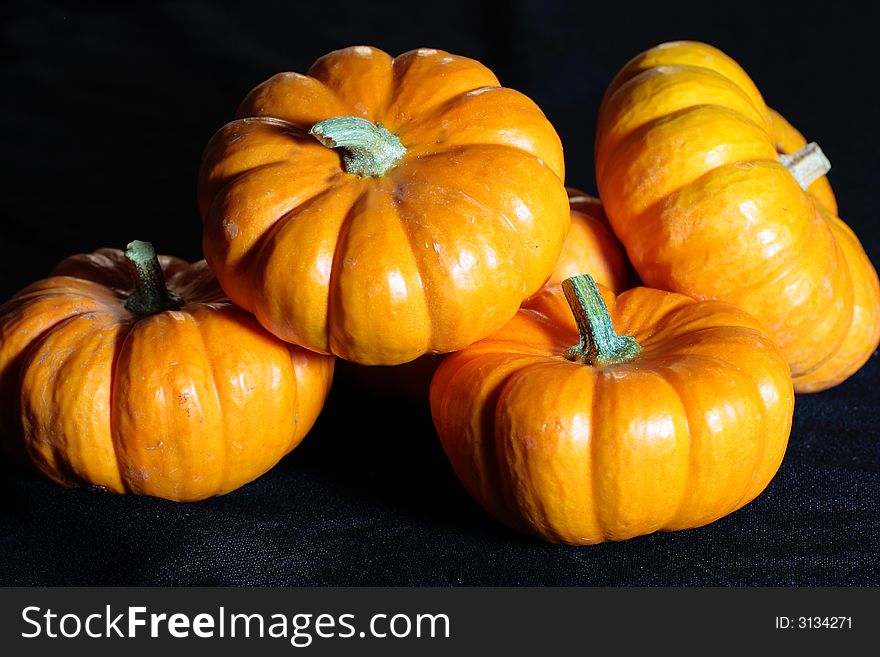 Vivid pumpkins against a black background - perfect for fall festivities.