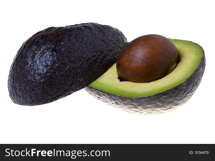 Avocado sliced in half isolated on white. Avocado sliced in half isolated on white.