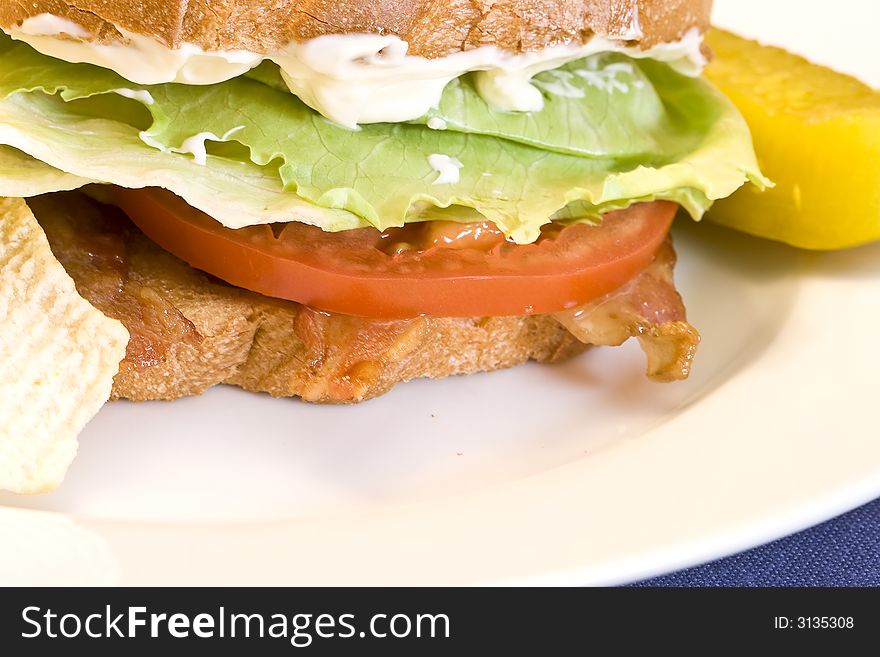 A fresh BLT sandwich with lots of bacon, fresh tomatoes,  lettuce and mayo