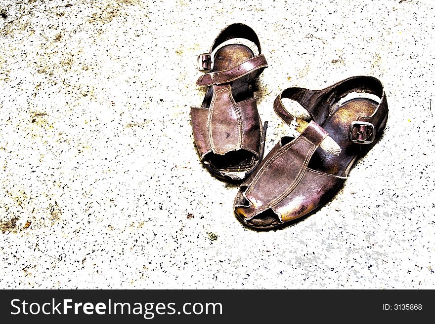 Old sandals on grunge background