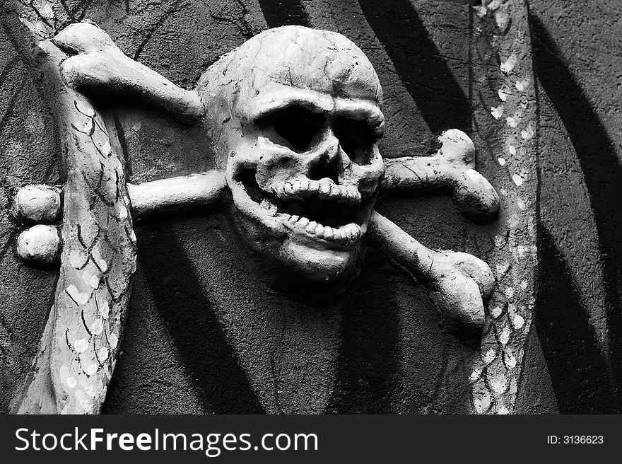Black and White image of skull imbeded in a wall.