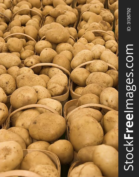 Baskets of potatoes at a farmer's market.