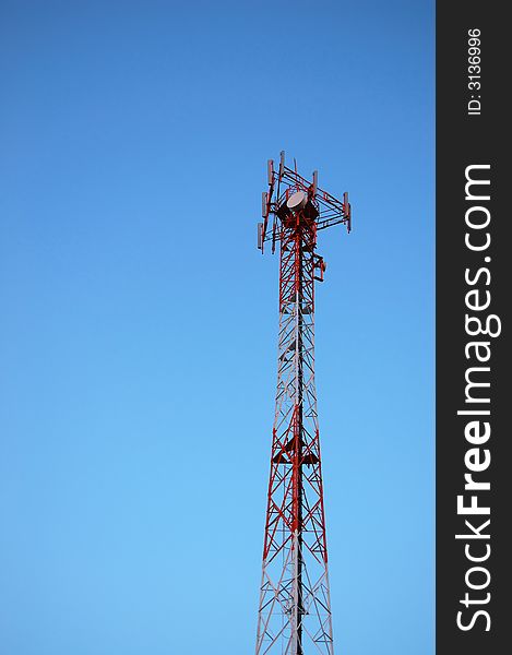 A mobile phone tower over a blue sky background.