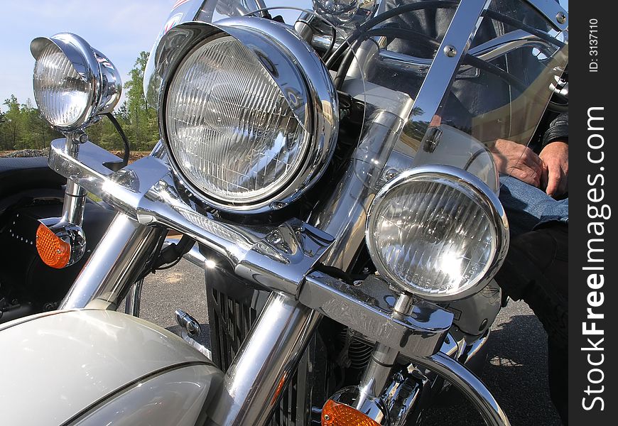 Close up of chrome motor cycle and rider. Close up of chrome motor cycle and rider