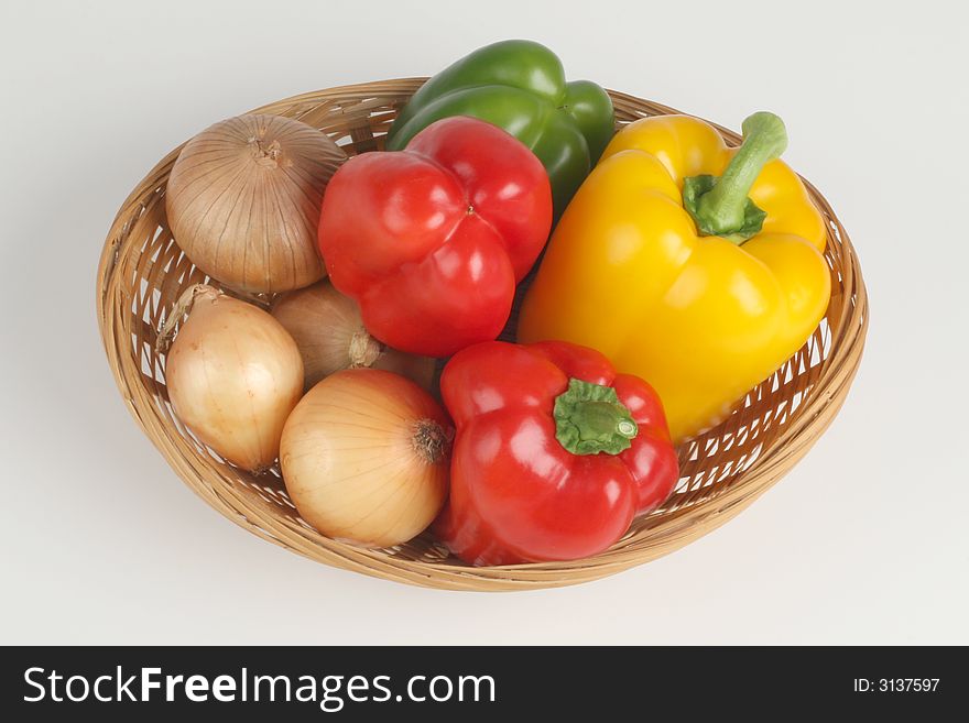 Basket with fresh peppers and onion. Basket with fresh peppers and onion