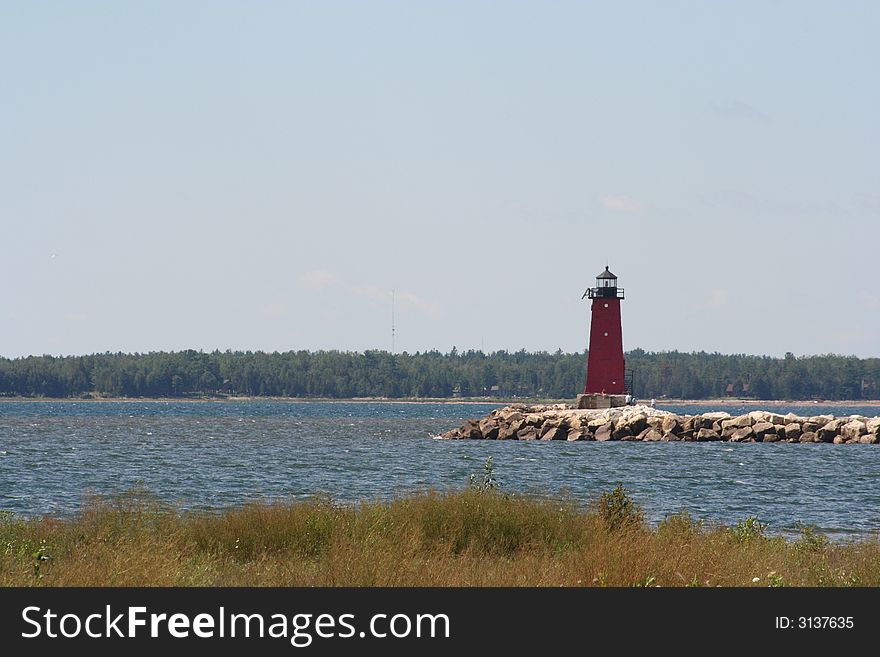 Red Lighthouse in the bay of Lake Mishigan. Red Lighthouse in the bay of Lake Mishigan