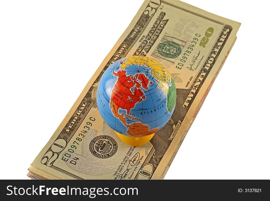 A globe sitting on isolated American dollars indicating a global currency
