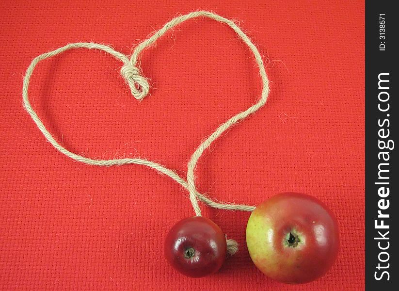 Red apple and string in form o