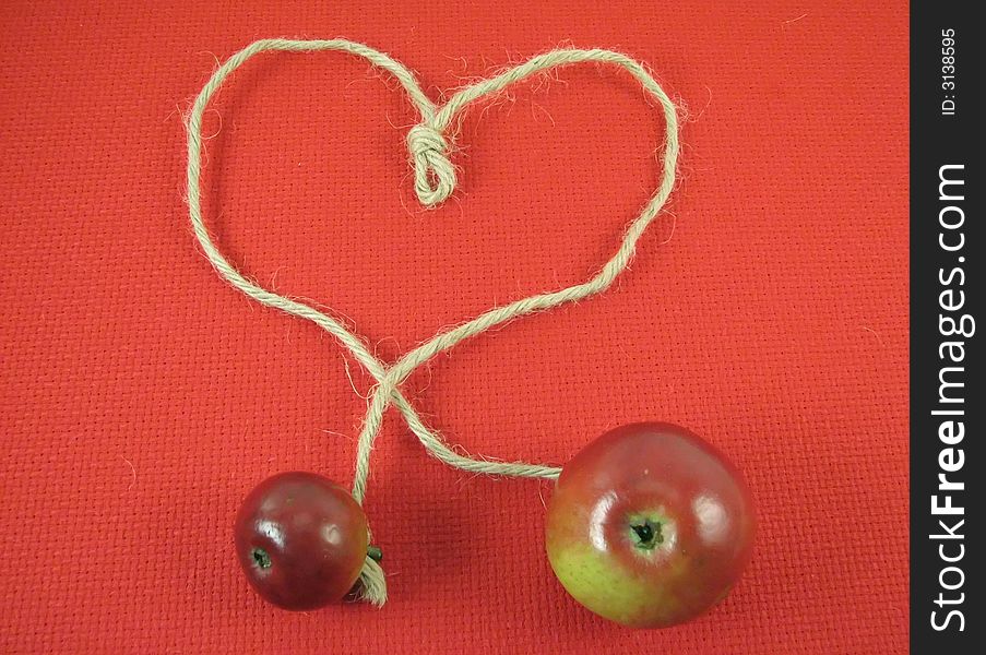 Red apple and string in form o