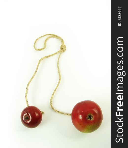 Composite: red apples and string on white background