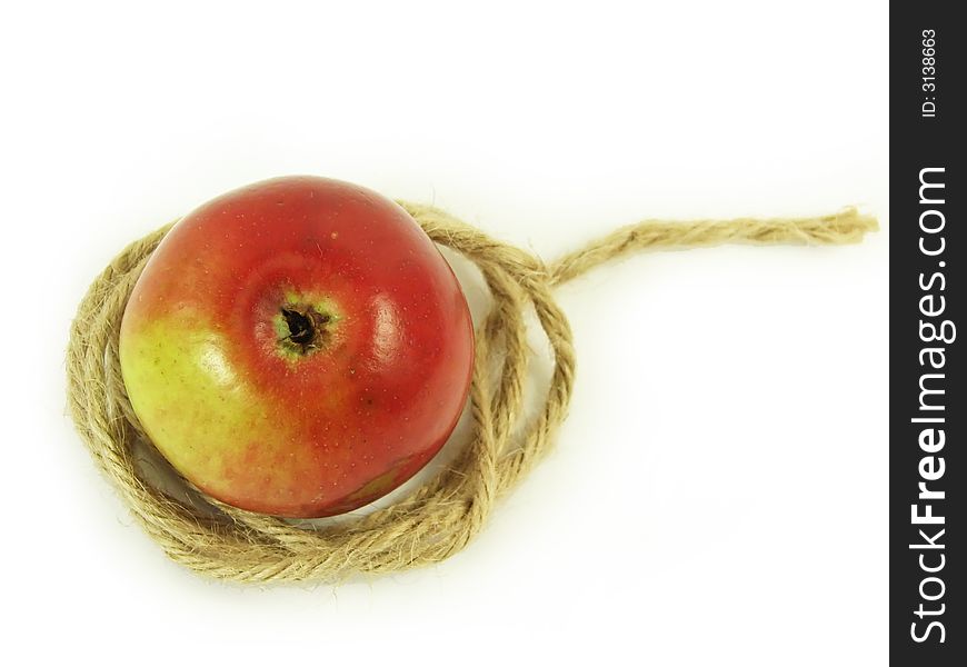 Composite: red apple and string on white background