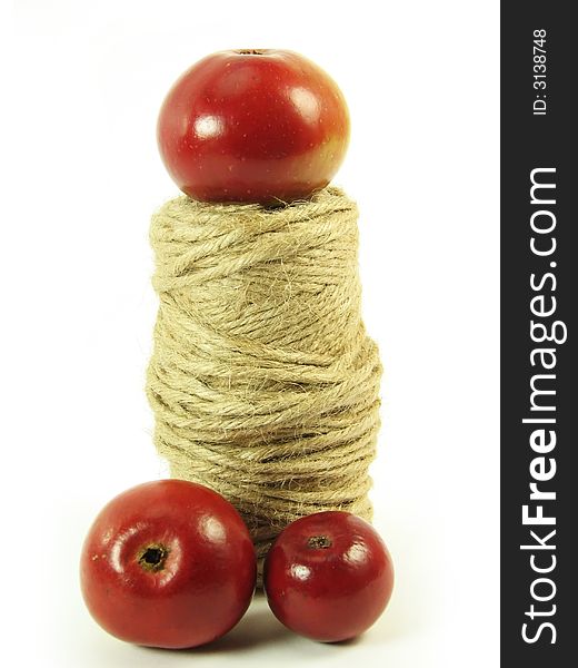 Composite: red apples and string on white background