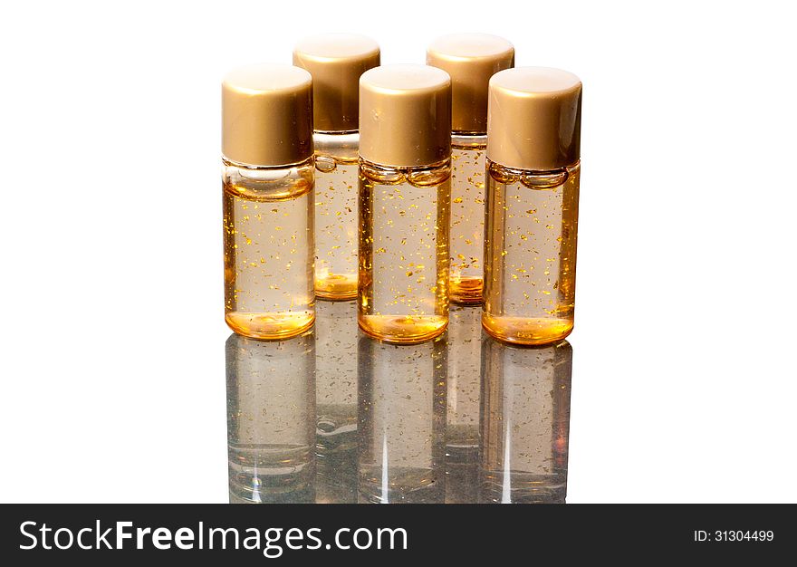 5 bottles of sample cosmetic with shadow on white background.