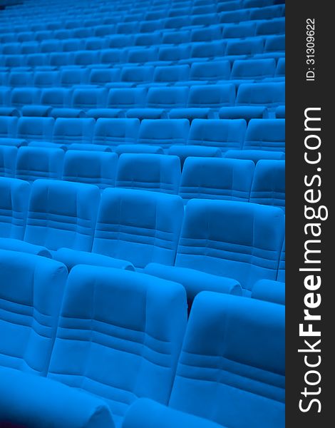 Rows of blue arm-chairs in empty auditorium. Rows of blue arm-chairs in empty auditorium