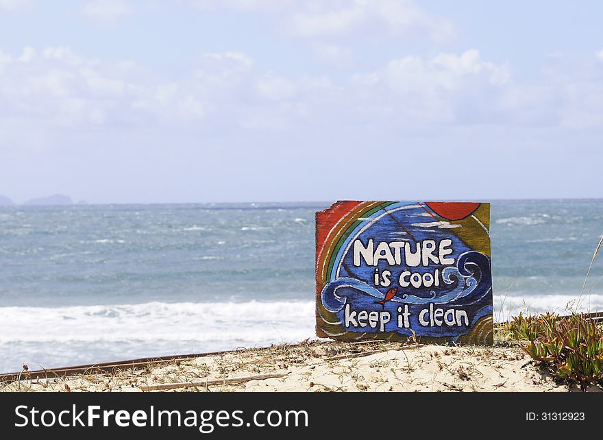 Nature is cool. Keep it clean. - Wooden sign on a dune beach, Peniche, Portugal. Peniche is one of the best surfing locations in Europe. It has beaches and breaks facing in 3 distinctly different directions. Recently it has become one of the destination for the WCT of the ASP or World championship tour of Association of surfing professionals.