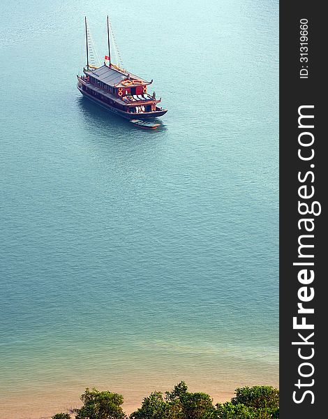 Ha Long Bay is a UNESCO world heritage site and a popular travel destination. Picture of cruise boat taken from top of an island mountain. Ha Long Bay is a UNESCO world heritage site and a popular travel destination. Picture of cruise boat taken from top of an island mountain.