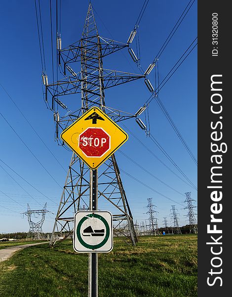 Electrical power line beside a bridge on a bright blue sky. Electrical power line beside a bridge on a bright blue sky