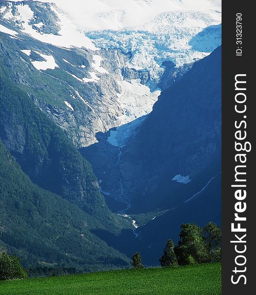 Landscape with a view of the and forest vegetation cloud lake glacier in the Norwegian mountains flows down the river. Landscape with a view of the and forest vegetation cloud lake glacier in the Norwegian mountains flows down the river