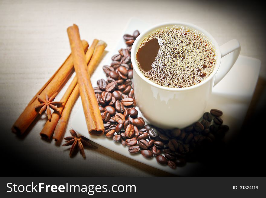 Cinnamon,anise with coffee beans white a cup coffee. Cinnamon,anise with coffee beans white a cup coffee
