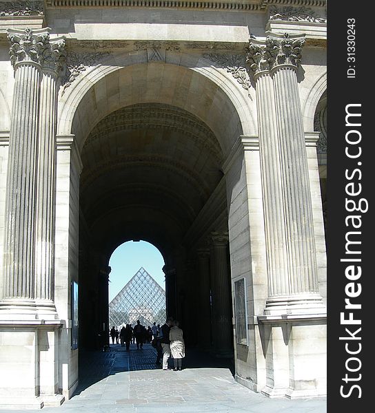 Detail architecture of passage to the interior court and glass structure of the Louvre museum in Paris, France