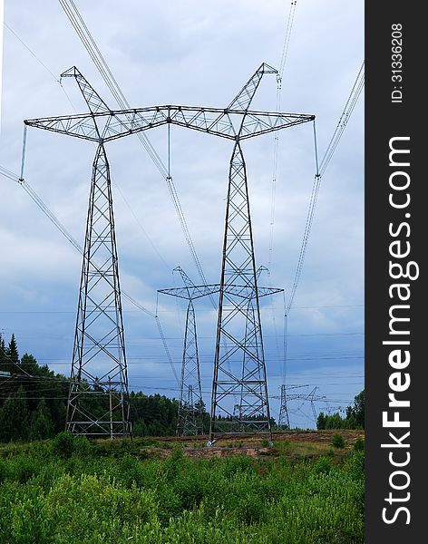 Electrical pylons against the cloudy sky background. Electrical pylons against the cloudy sky background