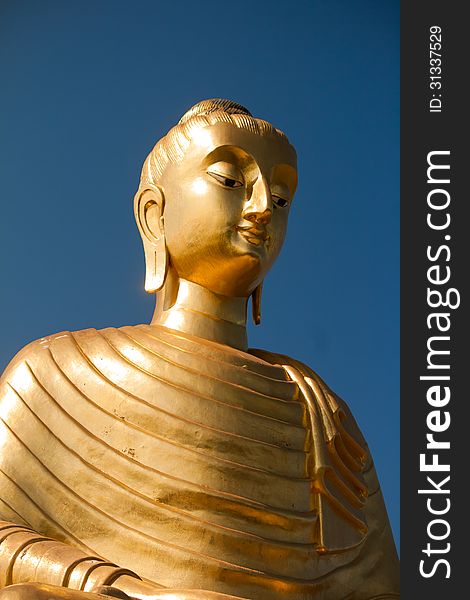 Golden buddha on blue sky. Golden buddha on blue sky
