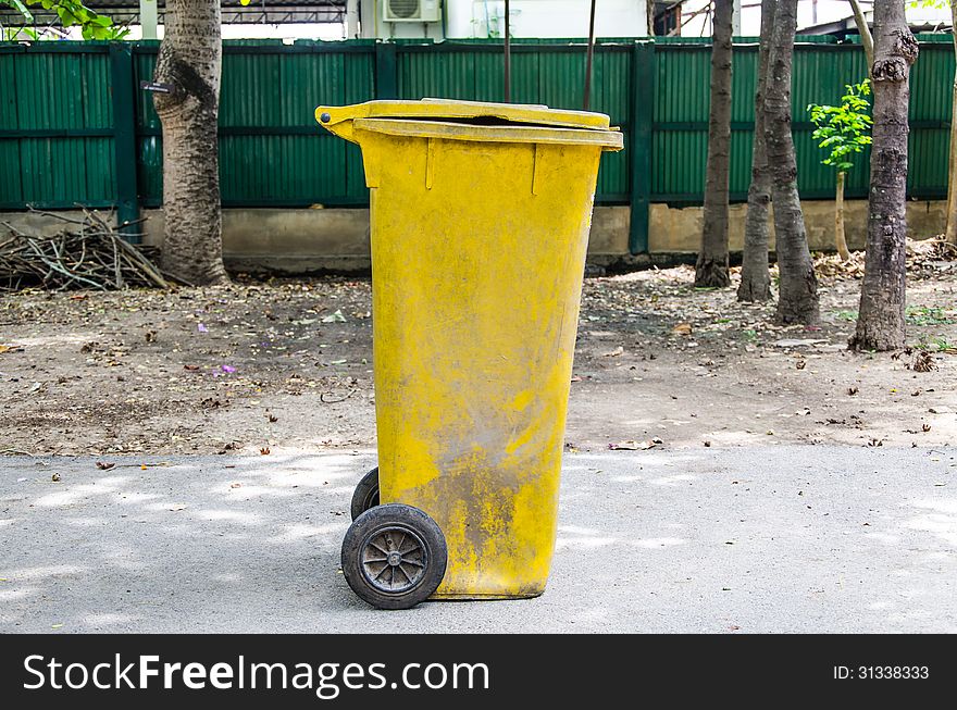 Old yellow recycling bin
