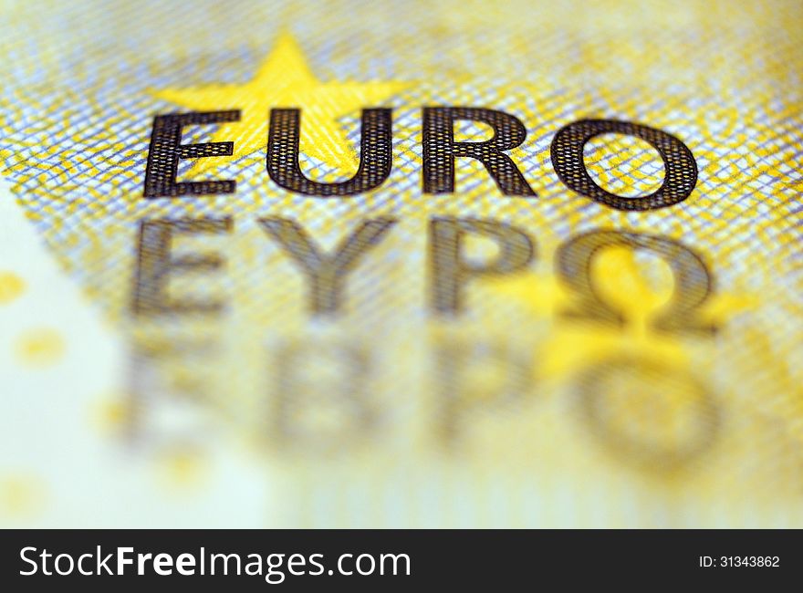 The word euro printed on banknote macro. The word euro printed on banknote macro