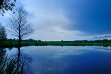 Calm Lake And Dark Blue Sky In The Evening Stock Photography Calm Lake And Dark Blue Sky In The Evening Stock Photography