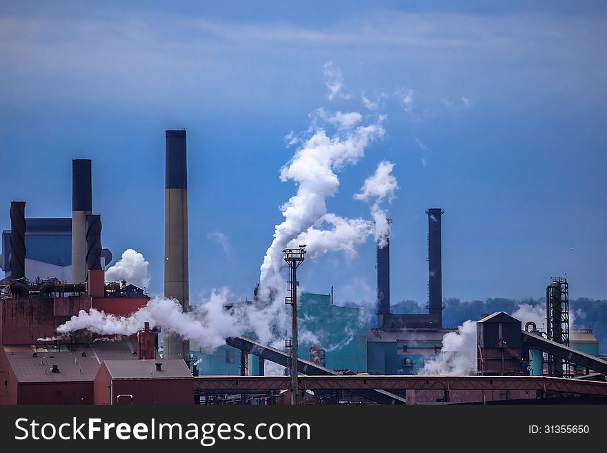 The view of smoking chimney-stalks of industrial plant