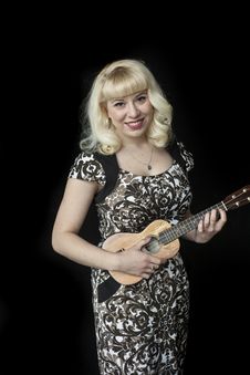 Beautiful Young Woman With Blond Hair Playing Ukulele Royalty Free Stock Photos Beautiful Young Woman With Blond Hair Playing Ukulele Royalty Free Stock Photos