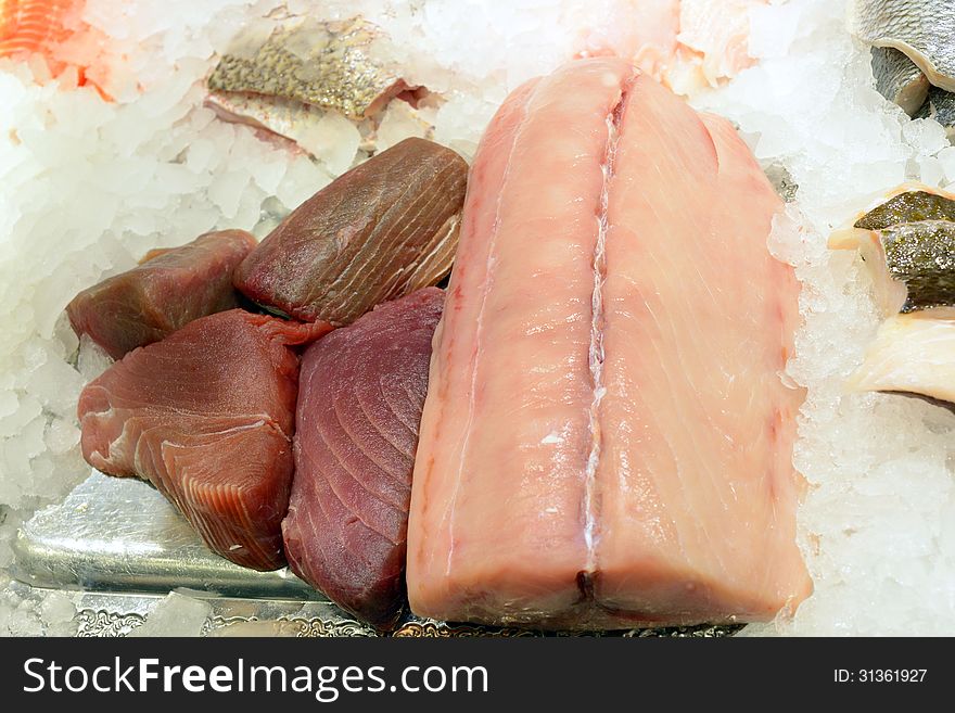 Closeup image of different fresh and delicious seafood filets on ice cubes. Closeup image of different fresh and delicious seafood filets on ice cubes.