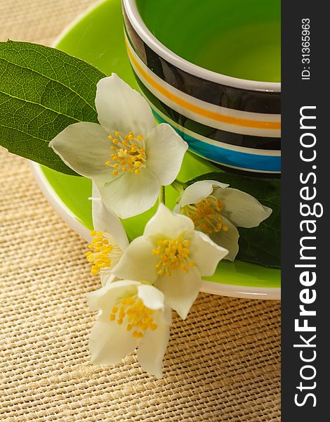 Cup of jasmine tea and jasmine flowers