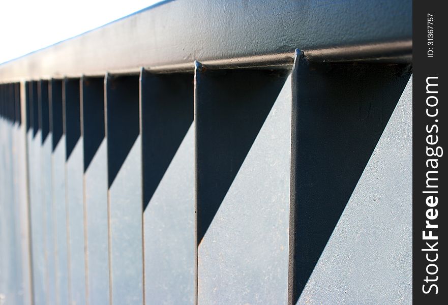 Detail of section of metal fencing on sunny light