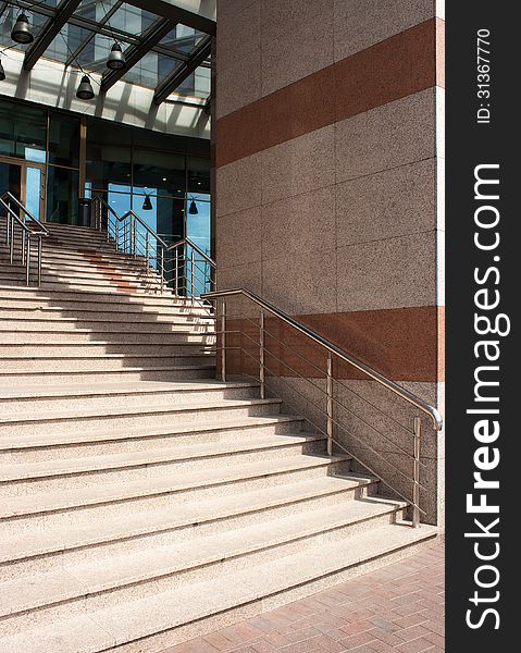 Outdoor granite staircase with metal railing of city house