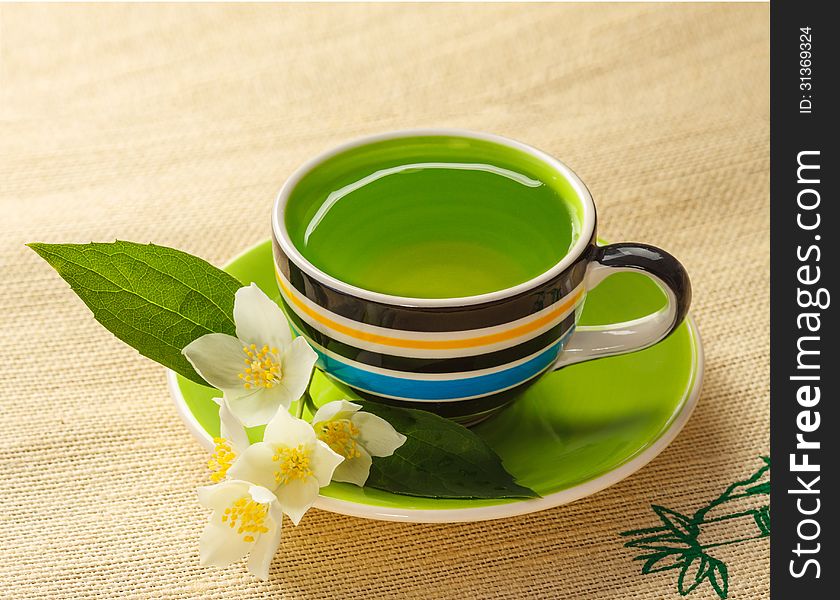 Cup of jasmine tea and jasmine flowers